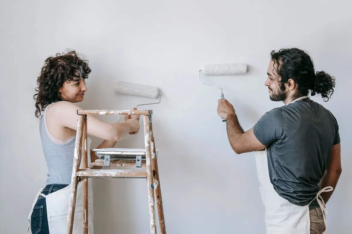 People painting a wall together — painting help in Peoria